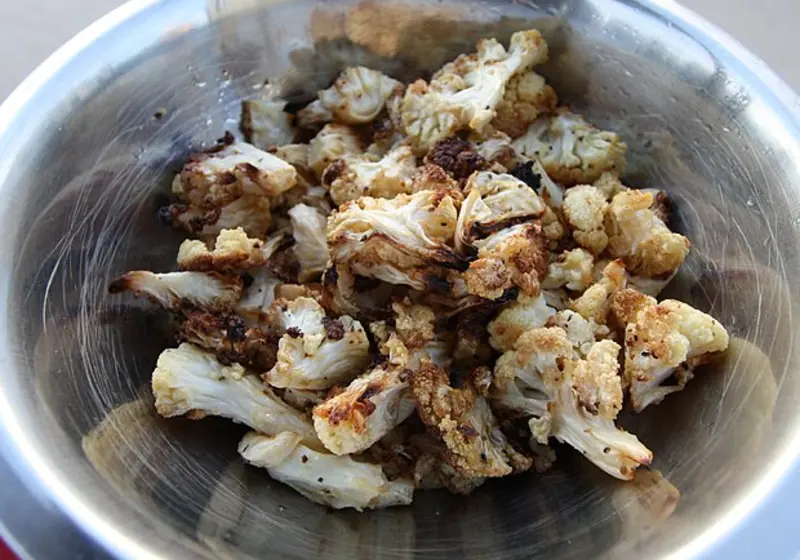 Roasted cauliflower florets with browned edges in a bowl